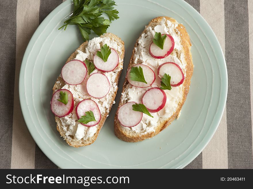 Sourdough with goat's cheese and radish on a plate. Sourdough with goat's cheese and radish on a plate