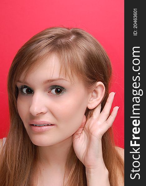 Portrait of a young woman on red