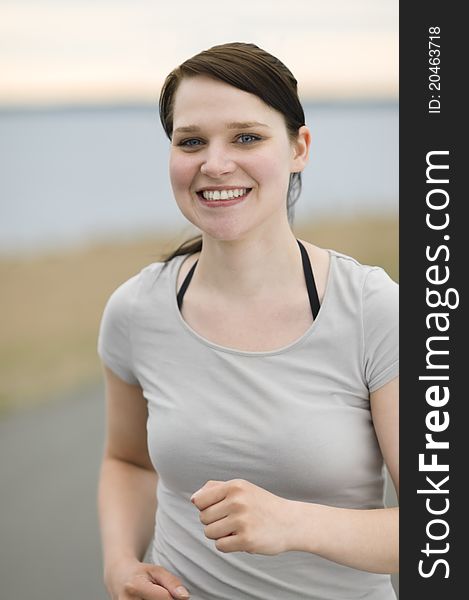 Beautiful young woman jogging on the beach