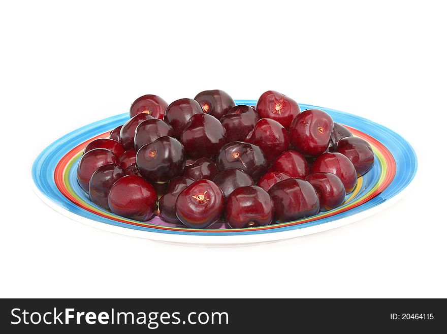Arranged cherries on the coloured plate