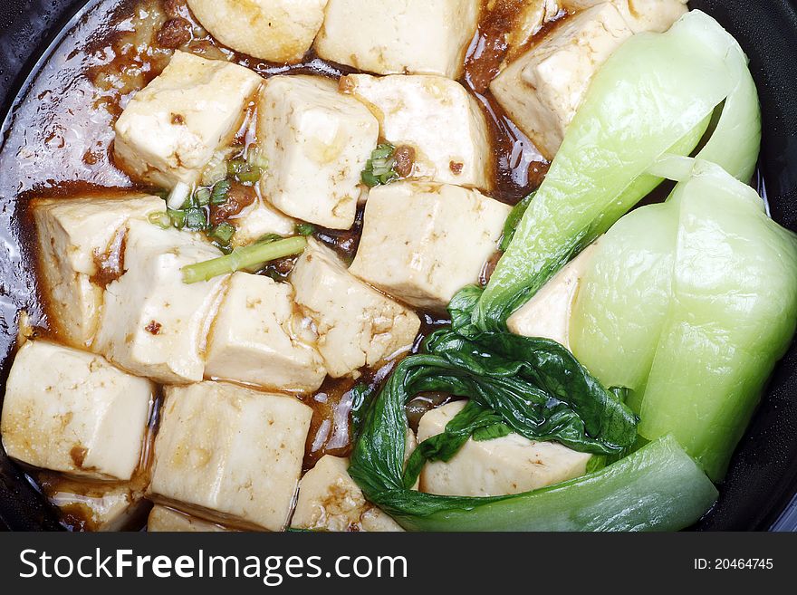 Close-up of attractive Chinese food. Chinese tofu with green vegetables .