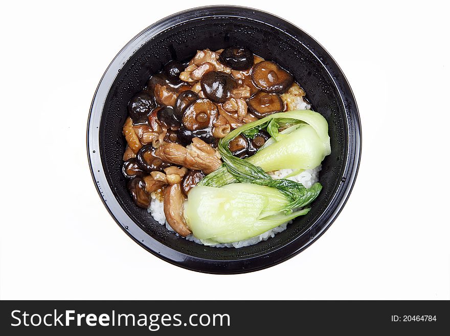 Chinese food in a dark bowl.(isolated on white) Stir-fried fresh mushrooms with green vegetables and rice.