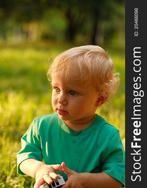 Portrait of serious little boy in summer nature. Portrait of serious little boy in summer nature