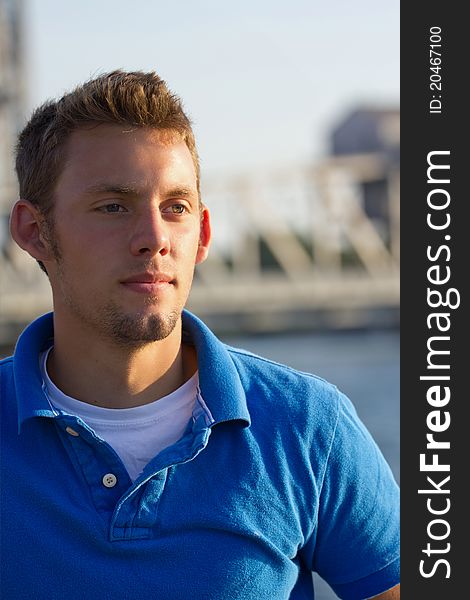 A young man portrait with bridge in background. A young man portrait with bridge in background