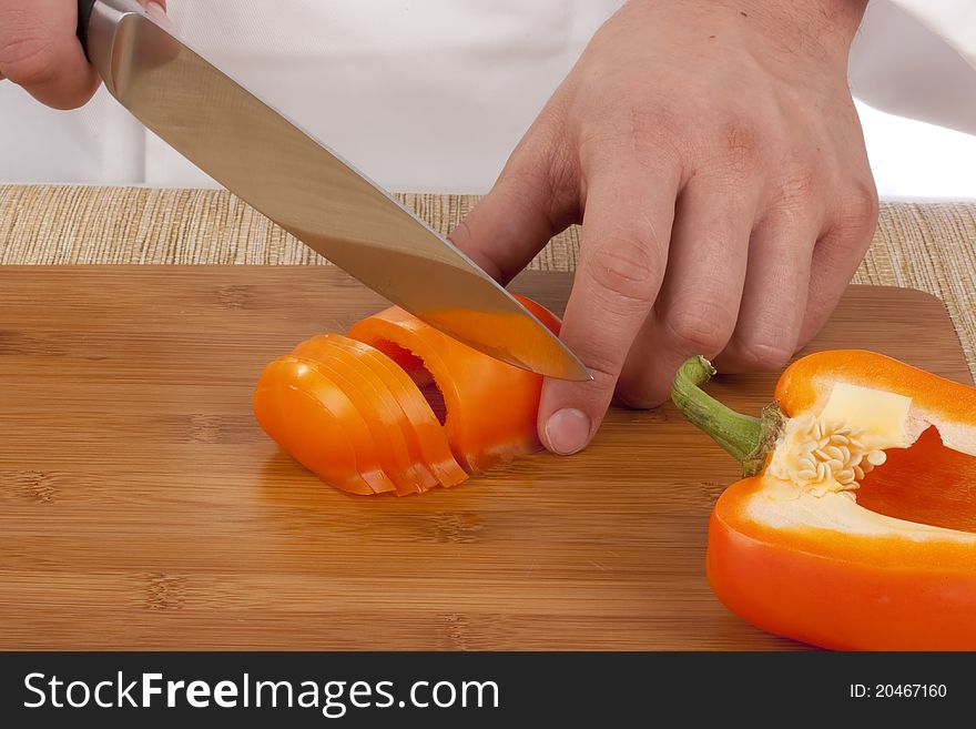 Chef Man cut vegetables on kitchen blackboard.