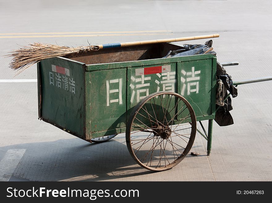Chinese style cleaning cart with broom on road, the Chinese characters on cart means cleaning daily