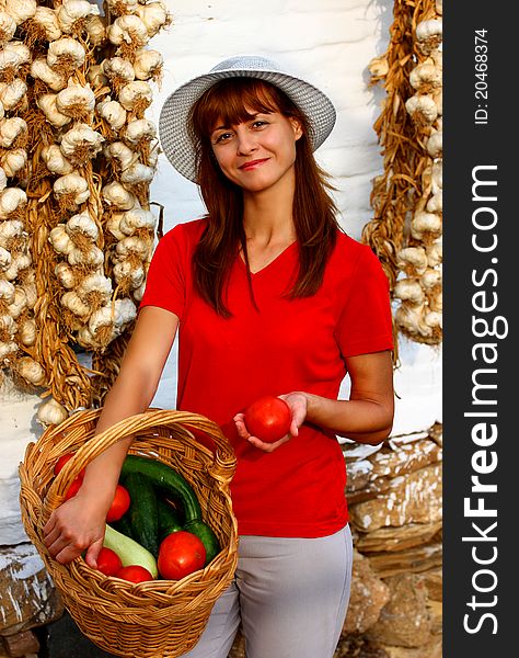 A woman holding basket with different vegetables. A woman holding basket with different vegetables