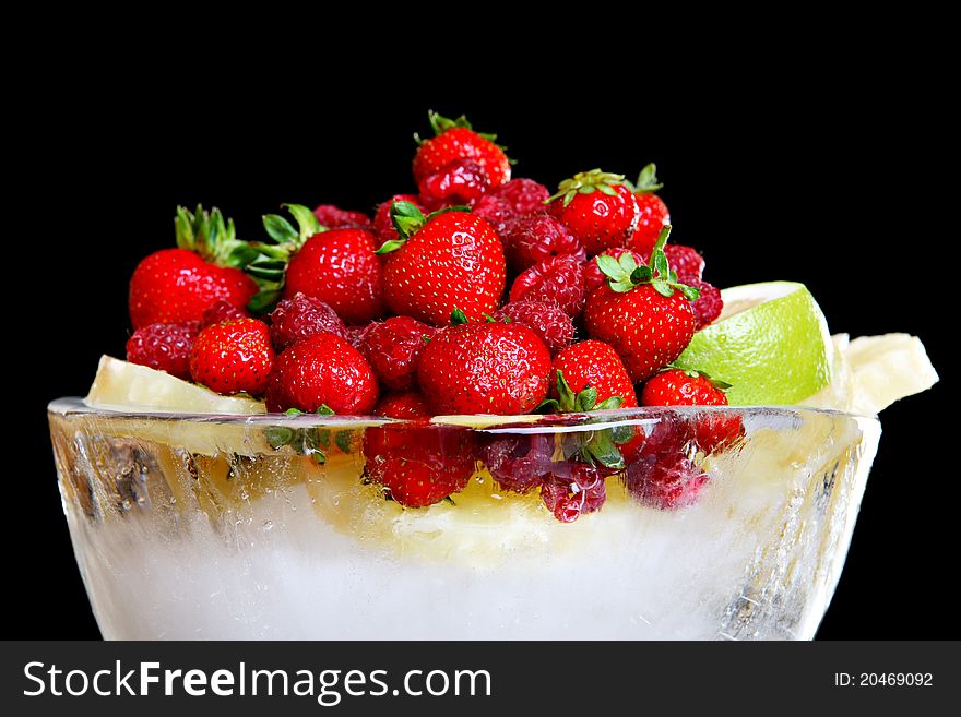 Different fruit in bowl made of ice