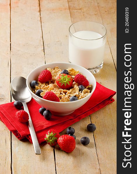 Photo of delicious breafast made of corn flakes with berries and fresh milk. Photo of delicious breafast made of corn flakes with berries and fresh milk