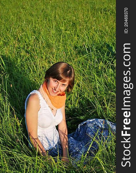 Young woman sitting in the grass. Young woman sitting in the grass