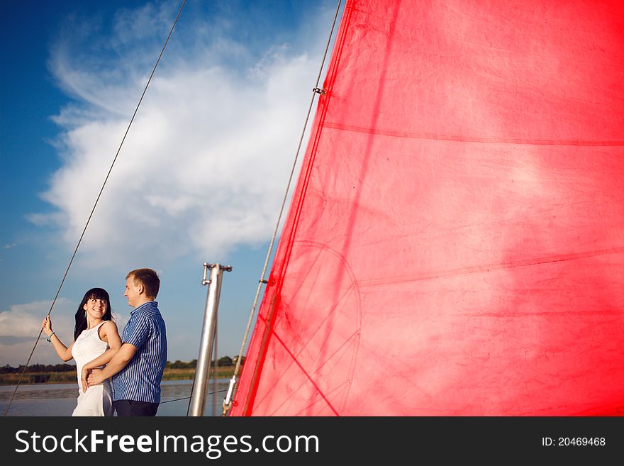 Man and girl under the red sail. Man and girl under the red sail