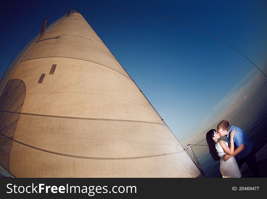 Man and girl under the sail. Man and girl under the sail