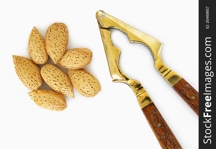 Almonds and antique nut cracker. Almonds and antique nut cracker