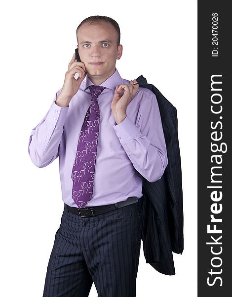 Young businessman in a suit talking by cell phone