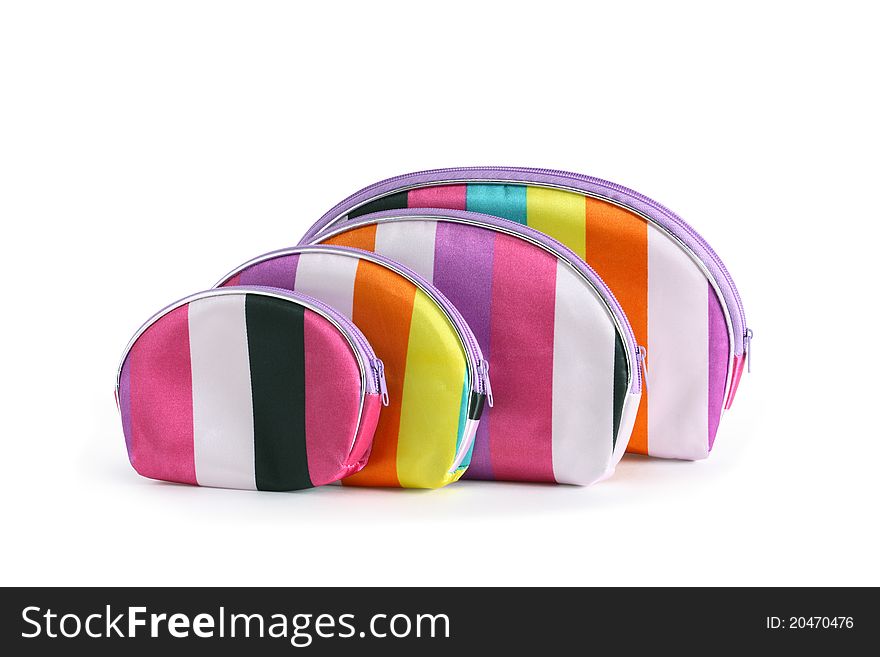 Few striped cosmetics bags in a row on white background. Isolated with clipping path