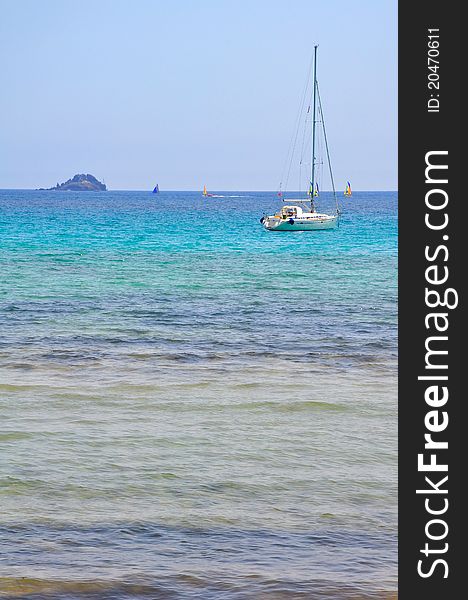 A sailboat on the horizon of the turquoise sea. A sailboat on the horizon of the turquoise sea