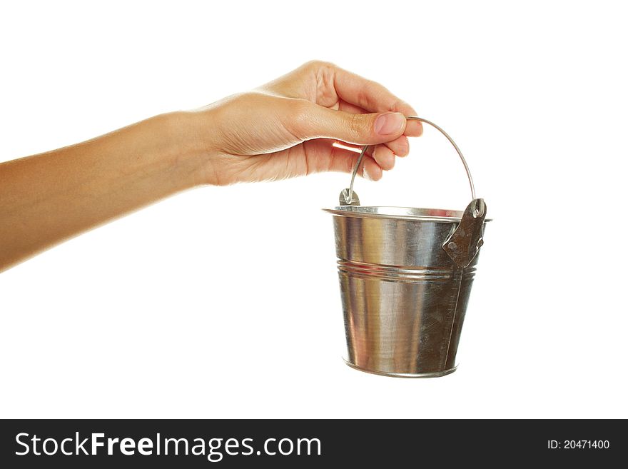 Close-up of female hand with an iron bucket. Isolated on a white background. Close-up of female hand with an iron bucket. Isolated on a white background