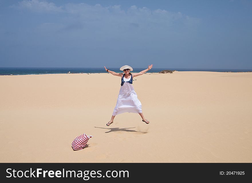 Woman Jumping On A Sand