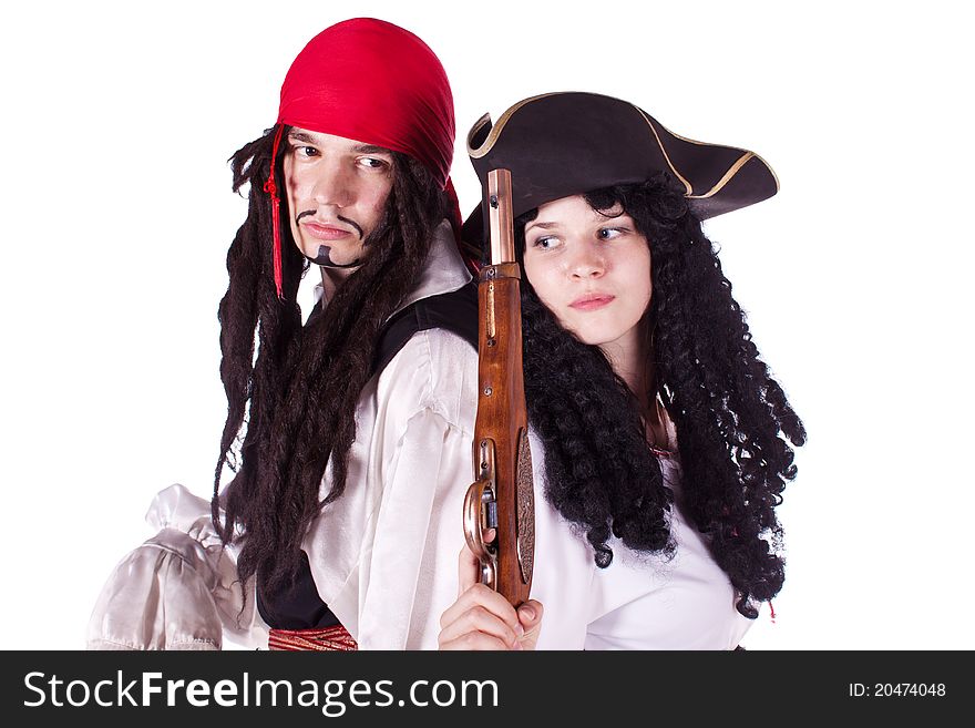A man and a woman dressed as a pirate, pistol and saber. White background. Studio photography. A man and a woman dressed as a pirate, pistol and saber. White background. Studio photography.