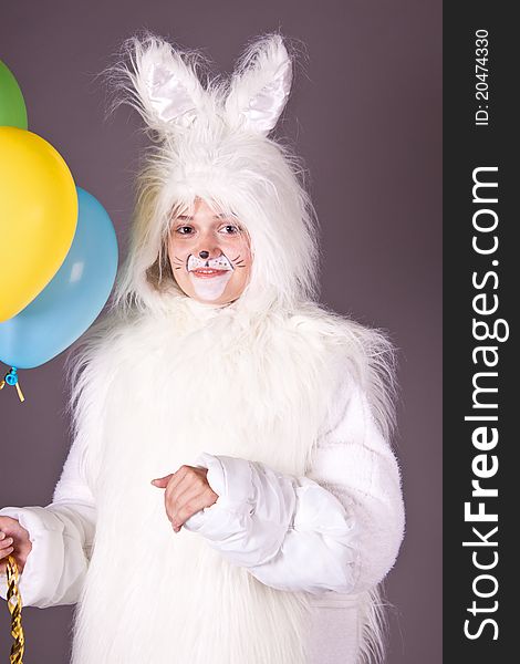 A girl in a white suit, hare, rabbit. Studio photography. A girl in a white suit, hare, rabbit. Studio photography.