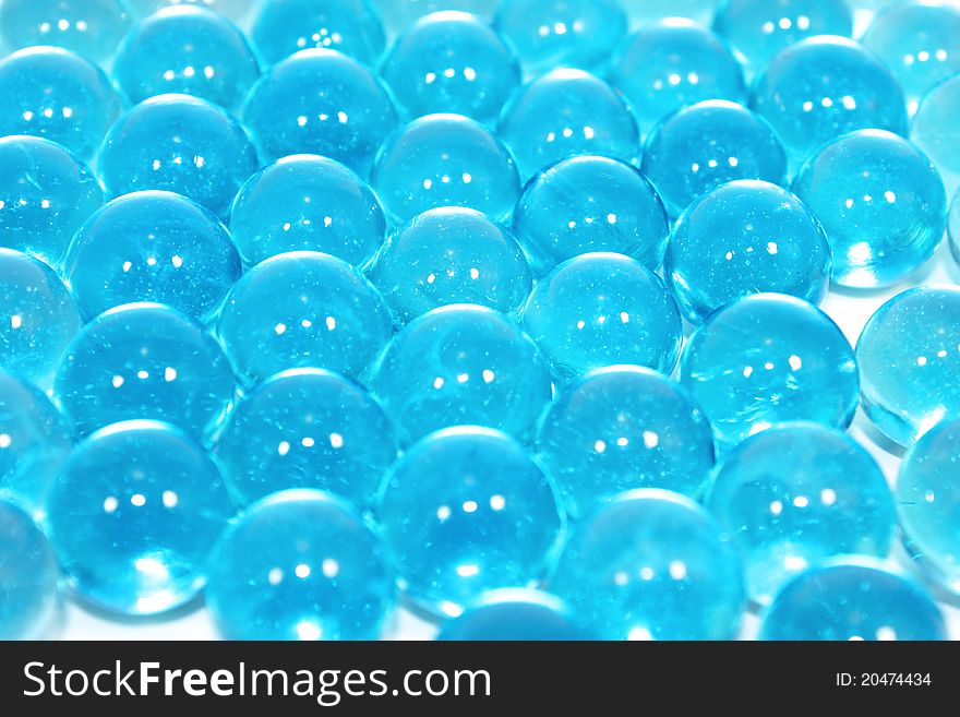 A background of colourful glass marbles. Blue version