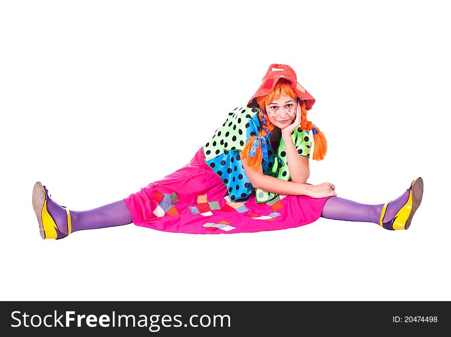 A girl dressed as a clown red. White background. Studio photography. A girl dressed as a clown red. White background. Studio photography.