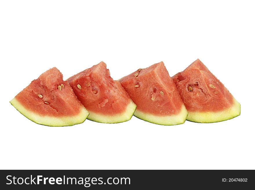 Four organic watermelon triangle slices upright side by side on white background. Four organic watermelon triangle slices upright side by side on white background.