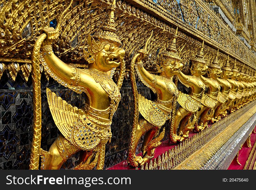 Thai art. Art in Wat Phra Kaew. Garuda gold Garuda standing around the palace. Valuable