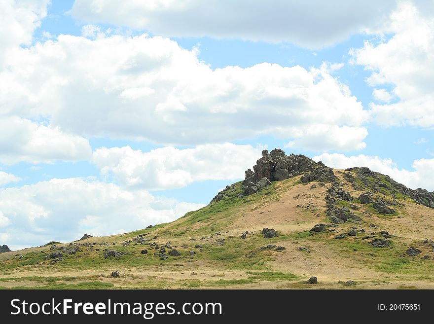 Steppe landscape. hill covered grass. sky with clouds