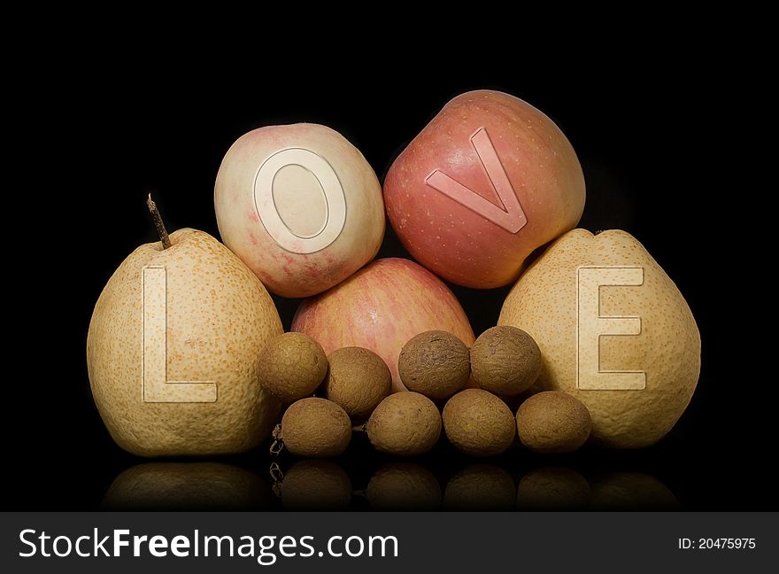 This is a group of fruit still life photography, background is black, fruit on the word LOVE. This is a group of fruit still life photography, background is black, fruit on the word LOVE.