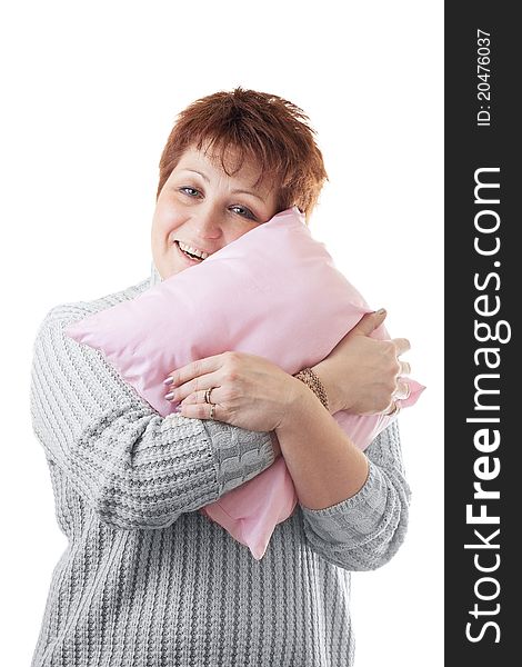 Happy woman hugs pink pillow isolated on white