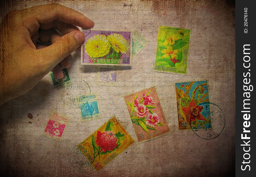 Vintage postcard with grunre background, hand and postage stamp