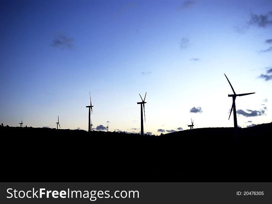 Wind farms, at sunset. Perpignan, Languedoc roussillon, Pyrenees Orientales, France. Bluesky with massive shadows.