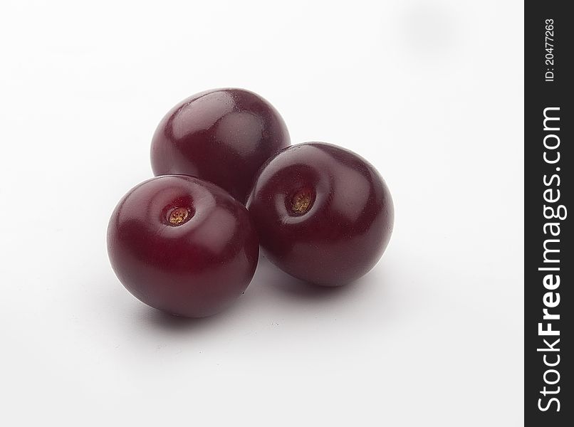 Some red cherries in the white background