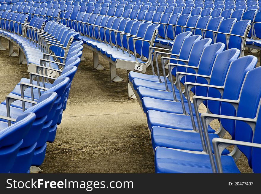 Rows of empty blue seats in a stadium. Rows of empty blue seats in a stadium