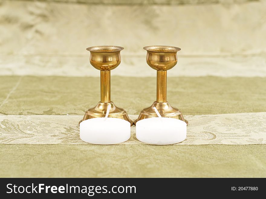 Bronze Candle Holders With Small Candles On Fancy Table Cloth Background