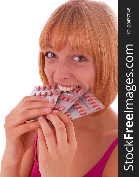A beautiful young woman biting into tablet packaging. A beautiful young woman biting into tablet packaging