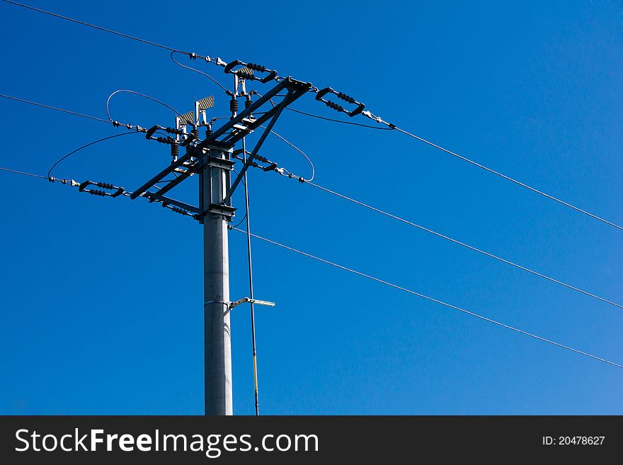 Electric high-voltage pole on the background of blue sky. Electric high-voltage pole on the background of blue sky