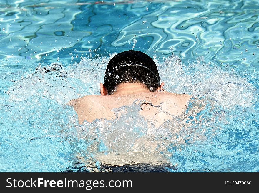 Professional Breaststroke swimmer in the outdoor pool. Professional Breaststroke swimmer in the outdoor pool