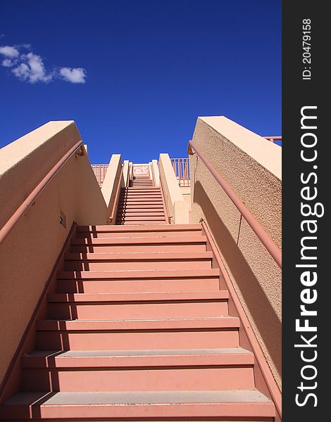 Stair case with red steps against blue sky. Stair case with red steps against blue sky