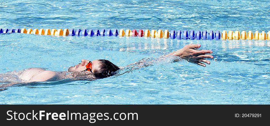 Backstroke swimming professional in the outdoor pool. Backstroke swimming professional in the outdoor pool