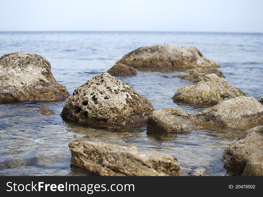 Several stones in Black sea, blurred water near the coast. Several stones in Black sea, blurred water near the coast