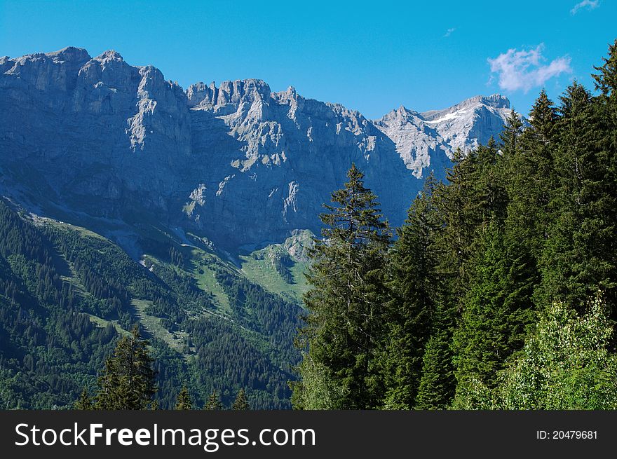 View on rocky mountains and evergreen forest in Swiss Alps. View on rocky mountains and evergreen forest in Swiss Alps