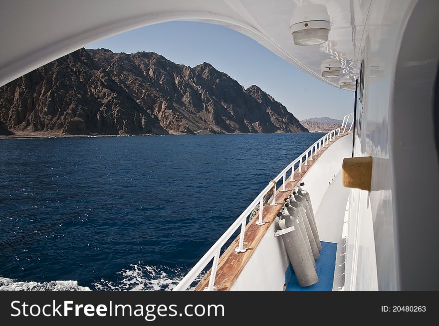 Scuba diving boat with desert in background. Scuba diving boat with desert in background