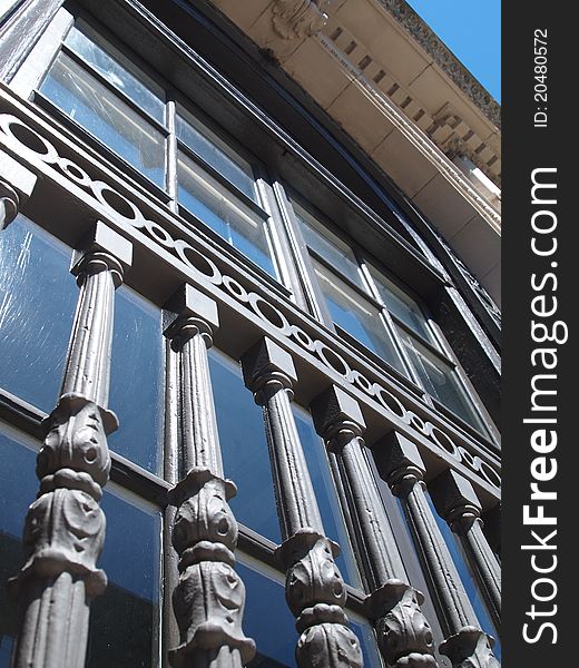 Looking up at an old bank building.  Classical details.