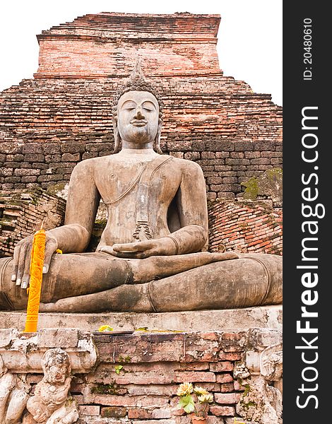 Ruin Buddha statue in front of ruin pagoda in Sukhothai historic park vertical. Ruin Buddha statue in front of ruin pagoda in Sukhothai historic park vertical