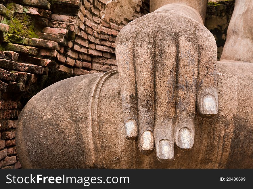 Hand of ruin Buddha statue in Sukhothai historic park on right. Hand of ruin Buddha statue in Sukhothai historic park on right