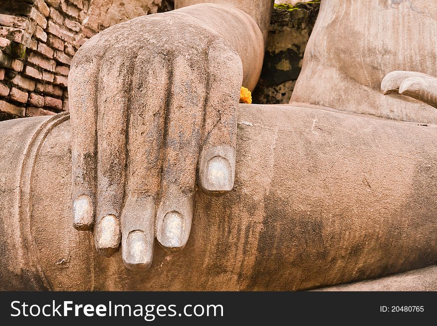 Hand of ruin Buddha statue in Sukhothai historic park on left. Hand of ruin Buddha statue in Sukhothai historic park on left
