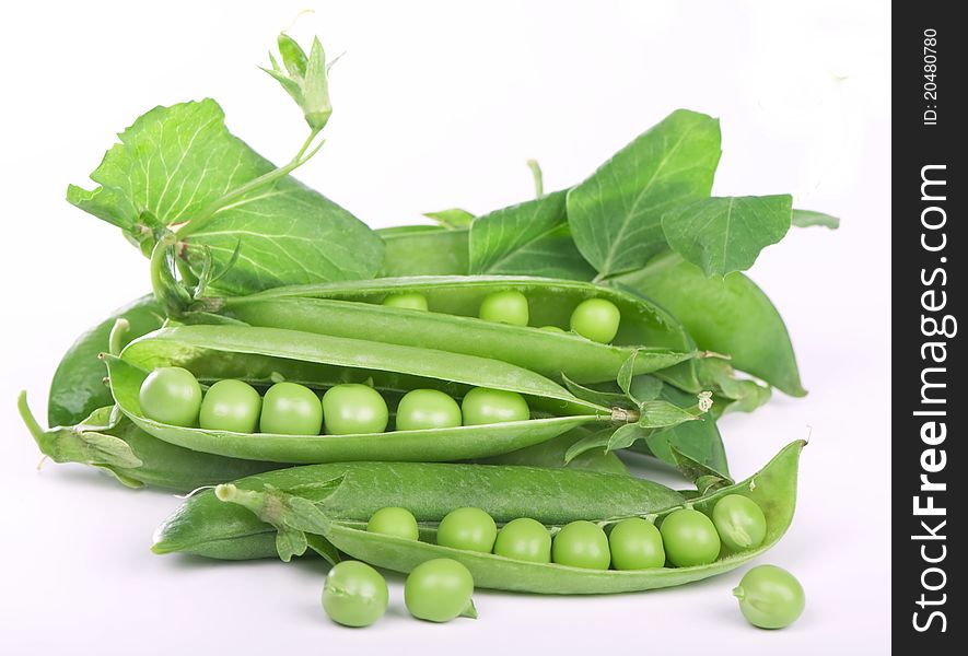 Green peas in pod close-up on white background