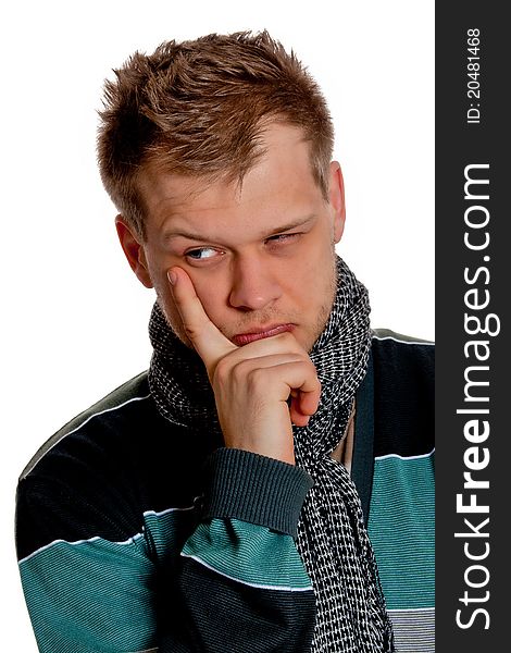 A young man in a gray-blue pullover intently thinking poses in the studio on a white background. A young man in a gray-blue pullover intently thinking poses in the studio on a white background